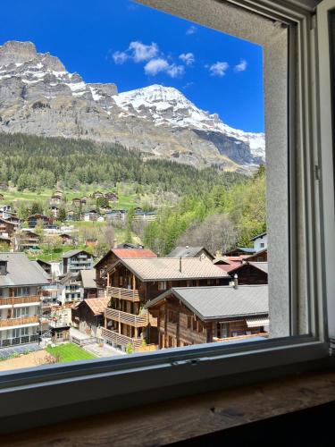 a window with a view of a mountain at Best views and location in Leukerbad! in Leukerbad