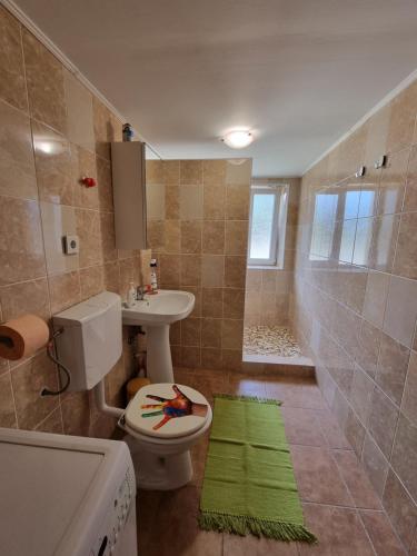 a bathroom with a toilet and a sink and a shower at Casa Maru in Jurilovca