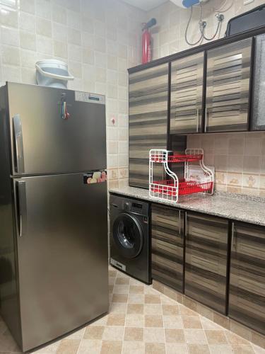 cocina con nevera de acero inoxidable y lavavajillas en One bedroom apartment in Jimi en Al Ain