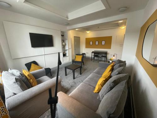 a living room with a couch and a table at Westm-3 Bdrm 3 bathrooms 1 EnSuite Fab for contractors Free Parking and Wi-Fi in Gateshead