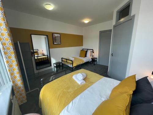 a hotel room with two beds and a mirror at Westm-3 Bdrm 3 bathrooms 1 EnSuite Fab for contractors Free Parking and Wi-Fi in Gateshead