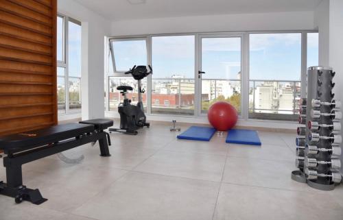 a room with a gym with a ball and a treadmill at Palermo Medrano Studio Suits in Buenos Aires