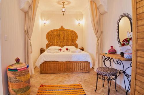 ein Schlafzimmer mit einem großen Bett und einem Spiegel in der Unterkunft DAR SOHAN Kasbah vue mer in Tangier