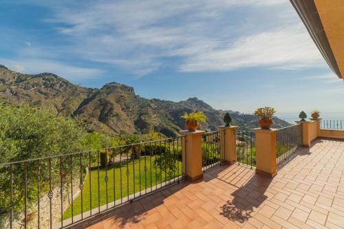 a balcony with a view of the mountains at Sea View Villa Taormina in Taormina
