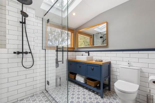a bathroom with a shower and a toilet and a sink at Judge & Jury Farm Retreat in Gibbston