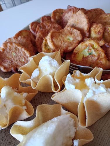 a plate of food with wontons and other foods at B&B e Home Restaurant S'ispera Monolocale uso esclusivo in Fonni
