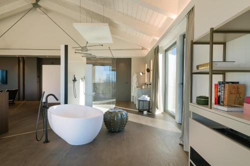 a bathroom with a large tub in the middle of the room at Le Cattedrali Relais by Laqua Collection in Asti