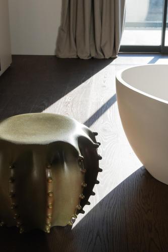 a bowl sitting on the floor next to a white bowl at Le Cattedrali Relais by Laqua Collection in Asti