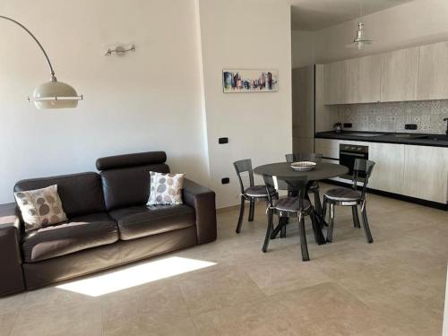 a living room with a couch and a table at La Maison Apache Gonnesa Cod IUN: R8196 in Gonnesa