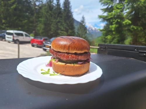 a sandwich on a plate on a table at Dom Klementa Juga in Lepena