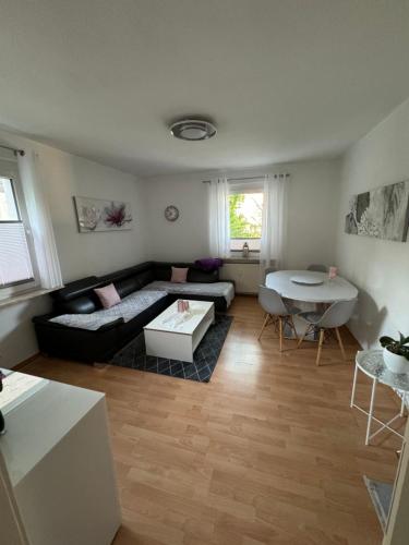 a living room with a couch and a table at Sana Ferienwohnung in Oberhausen