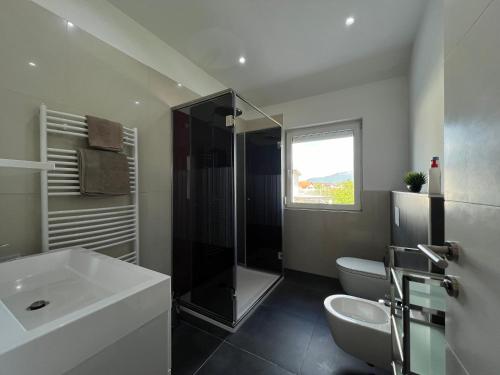 a bathroom with a shower and a sink and a toilet at Villa Amela in Ilidža
