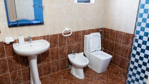 a bathroom with a toilet and a sink at Villa Osmani in Durrës
