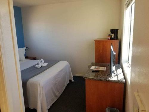 Zimmer mit einem Bett und einem Schreibtisch mit einem TV in der Unterkunft 075C Affordable Retreat near South Rim Sleeps 2 in Valle