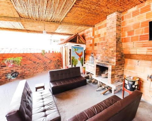 a living room with a couch and a fireplace at Hostal El Caminante in El Cocuy