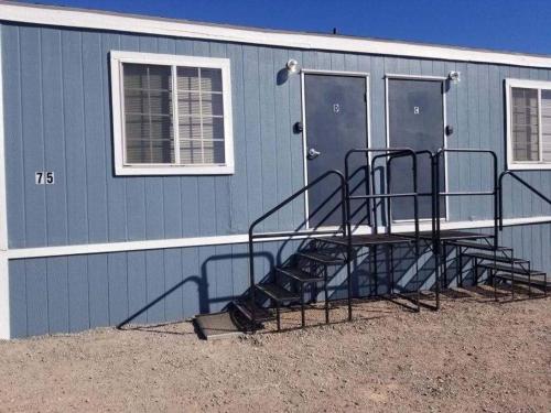 a blue building with stairs in front of it at 075D Cozy Retreat nr South Rim Sleeps 2 in Valle