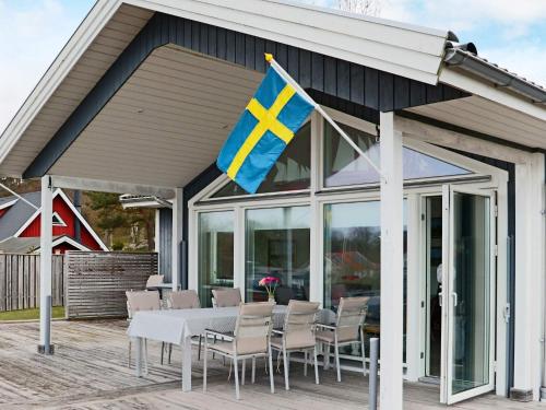 a flag on a patio with a table and chairs at 5 star holiday home in STENINGE in Steninge