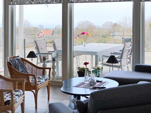 a living room with a view of a table and chairs at 5 star holiday home in STENINGE in Steninge