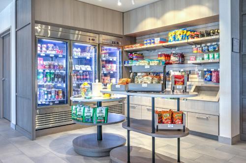 a grocery store with refrigerators and shelves of food at Home2 Suites By Hilton Huntsville, Tx in Huntsville