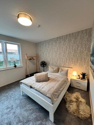 a bedroom with a large bed and a rug at Ferienwohnung Maasch in Vierraden