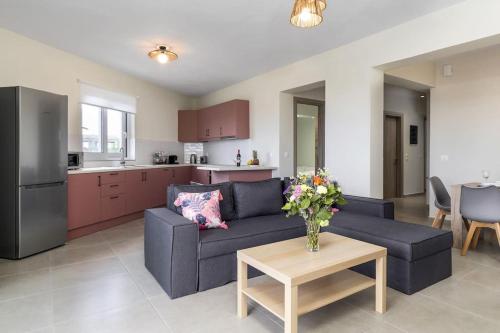 a living room with a couch and a table at ilios 3 bedroom apartment with sea view in town in Skala Kefalonias