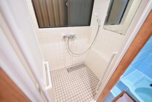 a small bathroom with a shower with a sink at Ichinagi Private Family Villa Near Nippori with Easy Access to Narita and Asakusa in Tokyo