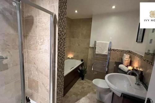 a bathroom with a shower and a toilet and a sink at Central Three Bedroom Flat I Sleep Up to 9 Guests in Brighton & Hove
