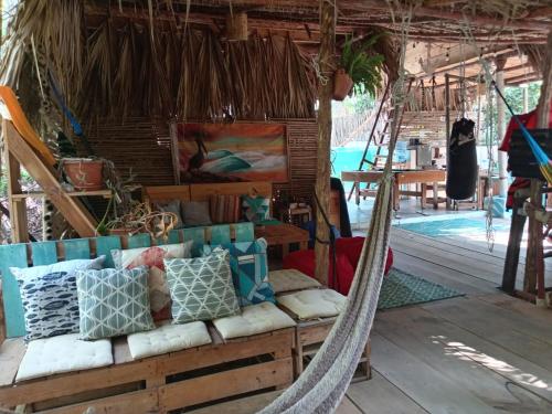 a couch in a hammock in a room at El Puente in El Paredón Buena Vista