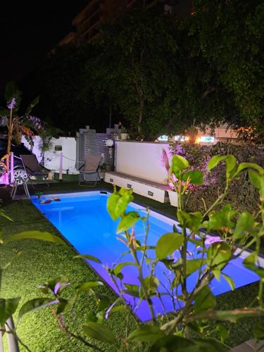 a swimming pool in a yard at night at Casa Le Rose in Palermo