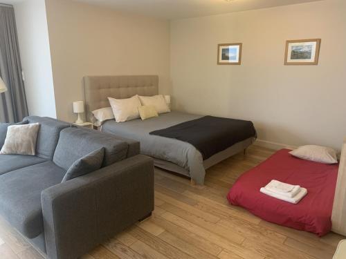 a living room with a bed and a couch at L'Aparté in Nancy