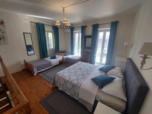 a bedroom with a bed and a couch at Alegria House 150m from the beach in Gouvia