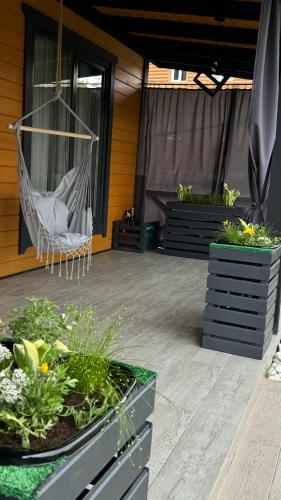 a hammock on a patio with some plants at Weekend house in Verkhovyna