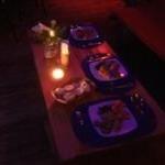 a group of food on a table with a candle at Villa La Caleta in Las Galeras