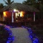 a house with blue lights in front of a house at Villa La Caleta in Las Galeras