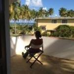 a person sitting in a chair looking out of a window at Villa La Caleta in Las Galeras