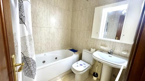 a bathroom with a tub and a toilet and a sink at Menendez Bohemian Dreams by Deihu Experiences in Los Cristianos