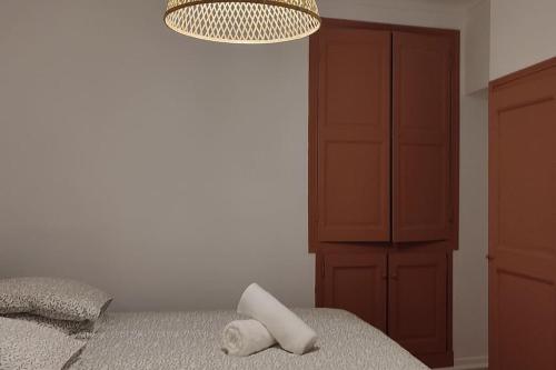 a bedroom with a bed and a chandelier at Appartement en Plein Centre au Pied des Musées in Grasse