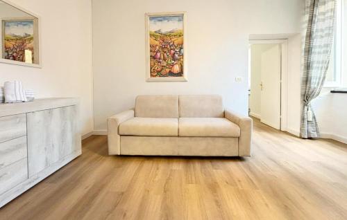 a living room with a chair and a painting on the wall at CINQUE TERRE MONEGLIA in Moneglia