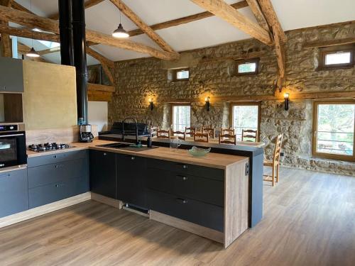- une grande cuisine avec une grande île dans l'établissement La maison de campagne, à Églisolles