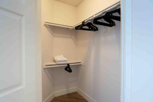 a walk in closet with black shoes and towels at Tulip - 2 bedroom apartment in West Hollywood in Los Angeles