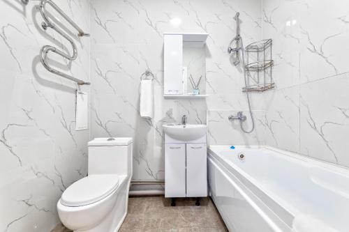 a white bathroom with a toilet and a sink at Набережная, небоскребы, кофейня, фитнес, стильно и недорого, ЖК 7Я in Astana