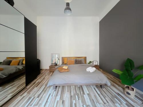 a bedroom with a large bed and a couch at Central Charm in Budapest's Bustling 7th District in Budapest