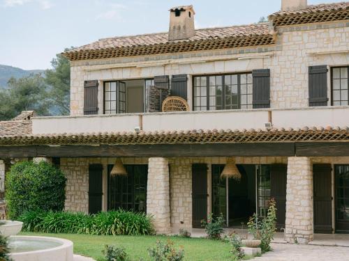 an exterior view of a large stone house at Le Mas Baïeta in Vence