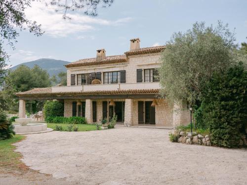 a large stone house with a large driveway at Le Mas Baïeta in Vence
