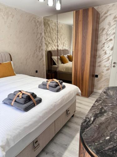 a bedroom with a bed with towels on it at Premium Suites in Stara Zagora
