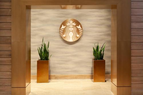 a room with two potted plants on a wall at Tampa Marriott Water Street in Tampa
