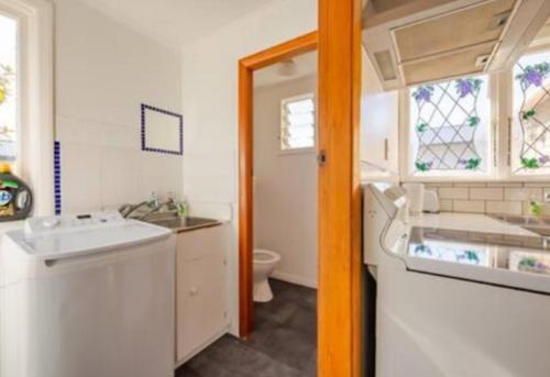 a small bathroom with a sink and a toilet at St Clair Holiday House in Dunedin