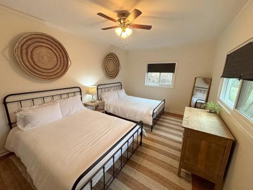 a bedroom with two beds and a ceiling fan at CHLChateau-Walkable to Hurricane Marina in Silver Point