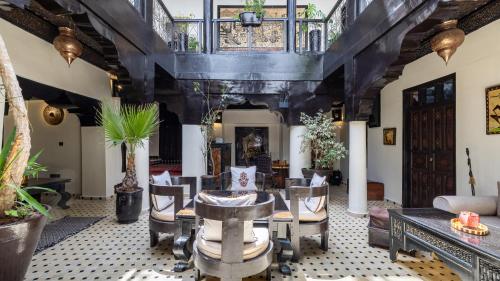 a living room with a table and chairs at Dar Najat in Marrakech