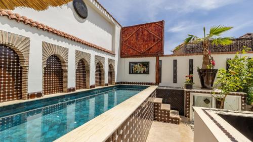a swimming pool in a villa with a house at Dar Najat in Marrakech